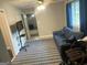 Inviting living area with a cozy sofa, a window with curtains, and a glimpse into the adjacent room at 6884 Shangrila Way, Riverdale, GA 30296