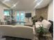 Bright living room with stone accent wall, opening to a kitchen and featuring outdoor access at 6884 Shangrila Way, Riverdale, GA 30296