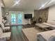 Bright and spacious living room boasts stylish furniture and access to the back yard at 6884 Shangrila Way, Riverdale, GA 30296