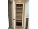 Open pantry with wood floor and five white shelves for optimal storage at 6884 Shangrila Way, Riverdale, GA 30296