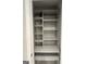 Open pantry shows well-spaced, painted shelves for organized storage at 6884 Shangrila Way, Riverdale, GA 30296