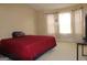 Bedroom featuring a red bedspread and white curtains at 3255 Hunters Crossing Pt, Lithonia, GA 30038
