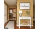 Bright entryway with wood floors, welcome sign, and a view into the dining room at 3255 Hunters Crossing Pt, Lithonia, GA 30038