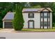 Inviting two-story home featuring solar panels, a garage, and neatly manicured landscaping at 3255 Hunters Crossing Pt, Lithonia, GA 30038