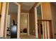 Hallway featuring 3 doorways and a wood railing with white spindles at 3255 Hunters Crossing Pt, Lithonia, GA 30038