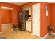 Kitchen area featuring a stainless steel refrigerator, white cabinets, and adjacent doorway at 3255 Hunters Crossing Pt, Lithonia, GA 30038