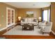 Living room with French doors, wood floors, and white sofa at 3255 Hunters Crossing Pt, Lithonia, GA 30038