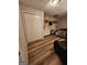 Bedroom featuring wood laminate flooring, built in shelving, and closet at 6340 Koweta Rd, Fairburn, GA 30213