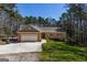 Charming brick home with an attached two-car garage and a spacious front yard in a wooded, tranquil neighborhood at 6340 Koweta Rd, Fairburn, GA 30213