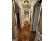 Bright hallway has laminate flooring and neutral paint, complemented by decorative trim and ample lighting at 6340 Koweta Rd, Fairburn, GA 30213
