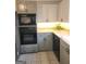 This kitchen features stainless steel appliances, neutral countertops, and plenty of natural light from window at 6340 Koweta Rd, Fairburn, GA 30213