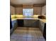 The spacious kitchen includes granite countertops, abundant cabinet space, and stainless appliances for a functional cooking space at 6340 Koweta Rd, Fairburn, GA 30213