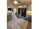 The spacious kitchen boasts stainless steel appliances, granite counters, and tile flooring for a modern feel at 6340 Koweta Rd, Fairburn, GA 30213