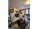 Living room featuring laminate flooring, a couch, and view into the kitchen at 6340 Koweta Rd, Fairburn, GA 30213