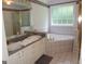Well-lit bathroom features double sinks, a tub, and a separate shower at 2958 Mary Alice Trl, Loganville, GA 30052