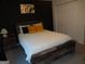 Serene bedroom with a comfortable bed, a modern accent wall, and ample closet space, designed for relaxation at 2958 Mary Alice Trl, Loganville, GA 30052