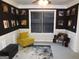 Well-lit sitting room with comfortable seating, a sleek black accent wall, and a modern, stylish decor at 2958 Mary Alice Trl, Loganville, GA 30052