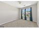 Bedroom with carpet flooring, light-colored walls, and two windows at 695 Georgetown Ct, Jonesboro, GA 30236