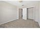 Bedroom with carpet flooring, light-colored walls, closet, and entry door at 695 Georgetown Ct, Jonesboro, GA 30236