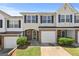 Charming townhome featuring a brick facade, garage, and manicured landscaping at 695 Georgetown Ct, Jonesboro, GA 30236