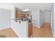 Open kitchen with a breakfast bar, modern appliances, and hardwood floors at 695 Georgetown Ct, Jonesboro, GA 30236