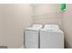 Functional laundry area with white washer and dryer and wire shelving at 695 Georgetown Ct, Jonesboro, GA 30236