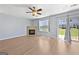 Spacious living room featuring a fireplace, ceiling fan, and sliding glass door at 695 Georgetown Ct, Jonesboro, GA 30236