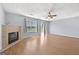 Bright living room featuring a fireplace, ceiling fan, and lots of natural light at 695 Georgetown Ct, Jonesboro, GA 30236