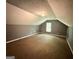 Finished attic space with carpeted floors and a window providing natural light at 270 Mountain Way, Covington, GA 30016