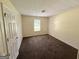 Neutral bedroom featuring carpeted floors, a window and a bright white door at 270 Mountain Way, Covington, GA 30016