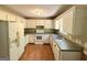 Functional kitchen featuring white cabinets and appliances, with ample counter space for meal preparation at 270 Mountain Way, Covington, GA 30016