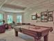Spacious basement featuring a billiard table, built-in desk, and natural light from the bay windows at 307 Worthing Ln, Mcdonough, GA 30253