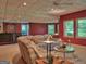 Finished basement features a comfortable seating area, a bar, and multiple windows, perfect for entertaining guests at 307 Worthing Ln, Mcdonough, GA 30253