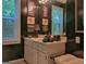 Bathroom with a vanity, decorative lamps, framed pictures, and natural light from the window at 307 Worthing Ln, Mcdonough, GA 30253