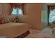 A bedroom with a patterned bedspread, a window with decorative valances, and warm lighting, creating a cozy ambiance at 307 Worthing Ln, Mcdonough, GA 30253