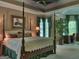 Main bedroom suite featuring a sitting area, large windows, and four poster bed at 307 Worthing Ln, Mcdonough, GA 30253
