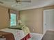 Bedroom features a comfortable bed, a window with blinds, and neutral decor, creating a peaceful retreat at 307 Worthing Ln, Mcdonough, GA 30253