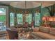 Bright dining room with large windows, chandelier, and seating for six people at 307 Worthing Ln, Mcdonough, GA 30253