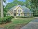 Charming two-story traditional home with mature landscaping and a well-manicured lawn at 307 Worthing Ln, Mcdonough, GA 30253