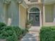 Elegant entryway features a dark double-door entry and mature landscaping at 307 Worthing Ln, Mcdonough, GA 30253
