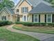 Beautiful home with a winding sidewalk, manicured landscaping, and mature trees at 307 Worthing Ln, Mcdonough, GA 30253