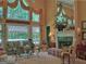 Elegant living room with a fireplace, tall windows, and plenty of natural light at 307 Worthing Ln, Mcdonough, GA 30253