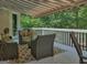 Rear porch with an awning and comfortable outdoor seating, offering a view of the lawn and trees at 307 Worthing Ln, Mcdonough, GA 30253