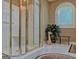 Glass-enclosed shower, seating and niche, in bright bathroom with neutral tones at 307 Worthing Ln, Mcdonough, GA 30253
