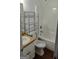 Well-lit bathroom featuring a shower-tub combo, a vanity sink with storage, and practical shelving at 1581 Jersey Social Circle Rd, Covington, GA 30014