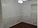 Cozy bedroom with neutral walls, chair railing, and hardwood flooring, creating a comfortable and inviting space at 1581 Jersey Social Circle Rd, Covington, GA 30014