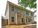 Back exterior of home showing light siding, multiple windows, and a door leading to a concrete patio at 2093 Parador Bnd, Mcdonough, GA 30253