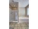 Bathroom showcasing a separate shower and tub, set against neutral walls and tiled floors at 2093 Parador Bnd, Mcdonough, GA 30253
