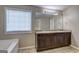 Bathroom features a double vanity, granite counters, and a large window for natural light at 2093 Parador Bnd, Mcdonough, GA 30253