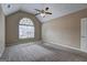 Bedroom boasts a large window, vaulted ceilings, and neutral carpeting for a cozy feel at 2093 Parador Bnd, Mcdonough, GA 30253